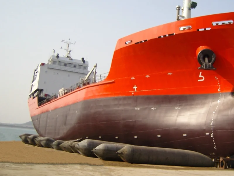 Vessel resting on marine launching airbags at a shipyard slipway before launch