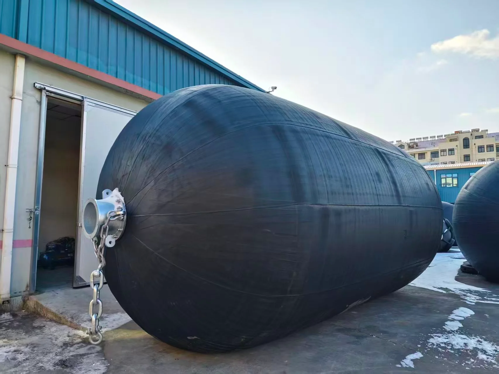 Submarine berthed alongside a quay protected by vertically installed hydro-pneumatic fenders at the waterline
