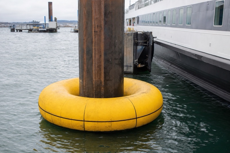 Donut fender encircling a steel monopile at a tidal berth